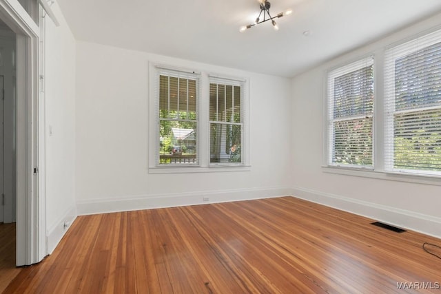 610 Ponce De Leon Ave, Montgomery, AL 36106 - spare room with healthy amount of natural light, a chandelier, and wood finished floors