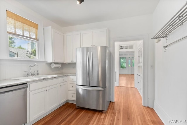 610 Ponce De Leon Ave, Montgomery, AL 36106 - kitchen with stainless steel appliances, light wood finished floors, white cabinets, and light stone countertops