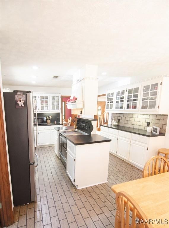 1267 County Road 85th Rd, Prattville, AL 36067 - kitchen featuring freestanding refrigerator, electric stove, dark countertops, decorative backsplash, and white cabinets