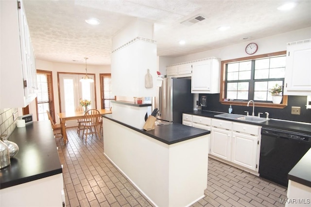 1267 County Road 85th Rd, Prattville, AL 36067 - kitchen featuring black dishwasher, freestanding refrigerator, dark countertops, brick patterned floors, and white cabinets