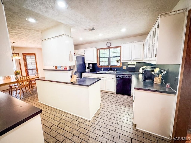 1267 County Road 85th Rd, Prattville, AL 36067 - kitchen featuring black dishwasher, dark countertops, healthy amount of natural light, white cabinetry, and a textured ceiling