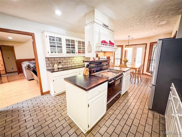 1267 County Road 85th Rd, Prattville, AL 36067 - kitchen featuring freestanding refrigerator, black range with electric cooktop, dark countertops, brick patterned floors, and recessed lighting