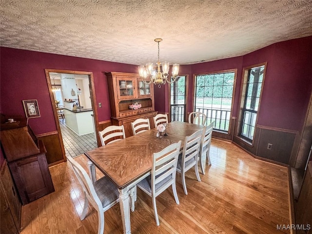 1267 County Road 85th Rd, Prattville, AL 36067 - dining room featuring a chandelier, light wood-style flooring, and a textured ceiling