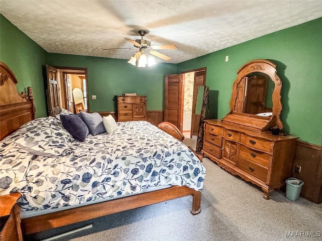 1267 County Road 85th Rd, Prattville, AL 36067 - bedroom featuring a textured ceiling, light colored carpet, wainscoting, a ceiling fan, and wood walls