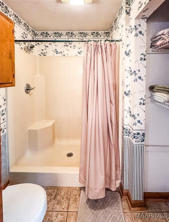 1267 County Road 85th Rd, Prattville, AL 36067 - bathroom with a shower with shower curtain, tile patterned flooring, and a textured ceiling