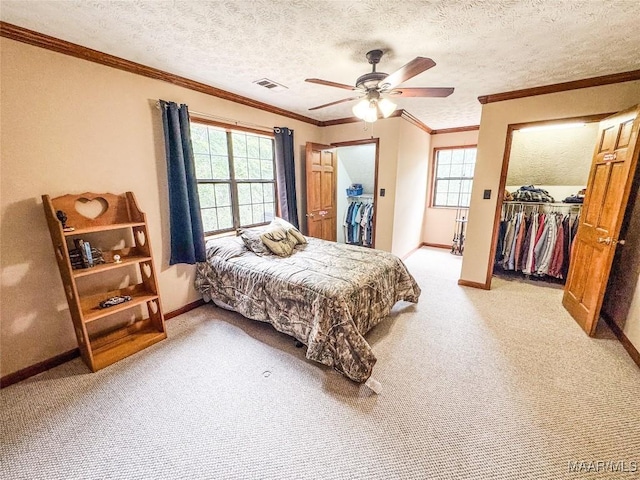 1267 County Road 85th Rd, Prattville, AL 36067 - bedroom with a walk in closet, a closet, multiple windows, ornamental molding, and a textured ceiling