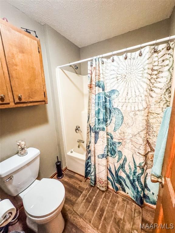 1267 County Road 85th Rd, Prattville, AL 36067 - full bathroom featuring a textured ceiling, shower / tub combo, and wood finished floors
