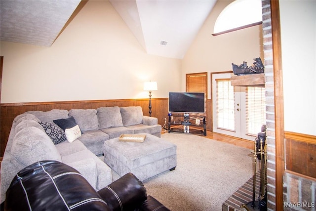 1267 County Road 85th Rd, Prattville, AL 36067 - living room with wainscoting, wood walls, lofted ceiling, healthy amount of natural light, and french doors
