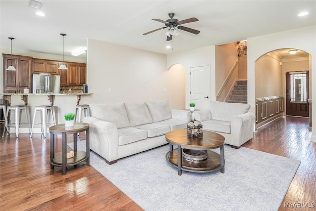 3915 Eagle Ridge Ln, Opelika, AL 36801 - living room with arched walkways, stairs, a ceiling fan, dark wood-type flooring, and recessed lighting