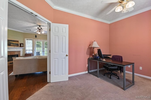 709 Liberty Rd, Tallassee, AL 36078 - office area featuring ceiling fan, ornamental molding, a tile fireplace, a textured ceiling, and carpet flooring