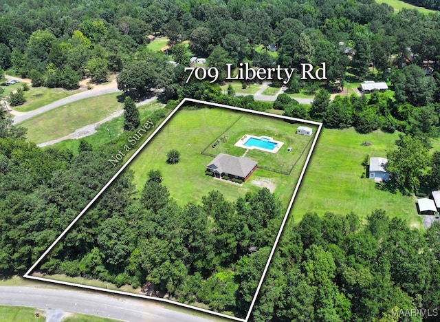 709 Liberty Rd, Tallassee, AL 36078 - aerial overview of property's location with property parcel outlined and a heavily wooded area