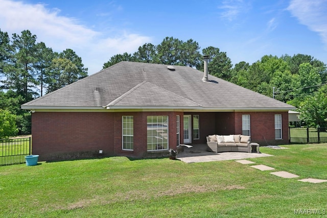 709 Liberty Rd, Tallassee, AL 36078 - back of property with outdoor lounge area, a patio area, brick siding, and roof with shingles