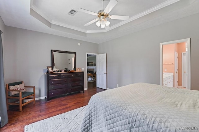 709 Liberty Rd, Tallassee, AL 36078 - bedroom with a tray ceiling, wood finished floors, crown molding, a ceiling fan, and connected bathroom