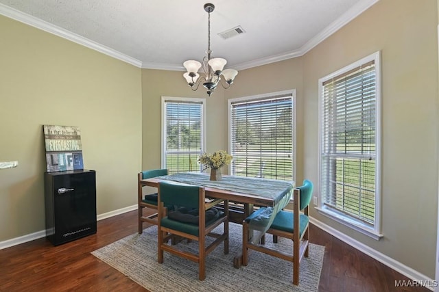 709 Liberty Rd, Tallassee, AL 36078 - dining room featuring a chandelier, crown molding, healthy amount of natural light, and dark wood finished floors