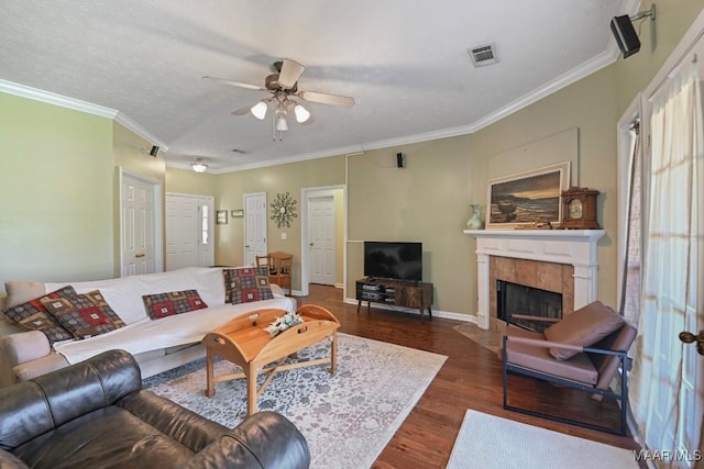 709 Liberty Rd, Tallassee, AL 36078 - living area featuring a ceiling fan, dark wood finished floors, a tiled fireplace, and crown molding