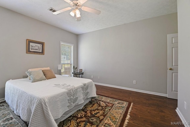 709 Liberty Rd, Tallassee, AL 36078 - bedroom with dark wood-style floors, a textured ceiling, and a ceiling fan