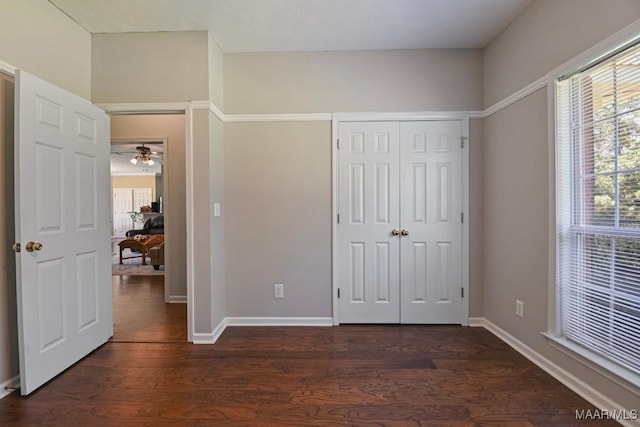 709 Liberty Rd, Tallassee, AL 36078 - unfurnished bedroom with dark wood finished floors and a closet