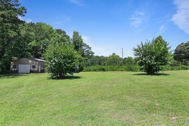 709 Liberty Rd, Tallassee, AL 36078 - view of grassy yard featuring a garage and an outbuilding