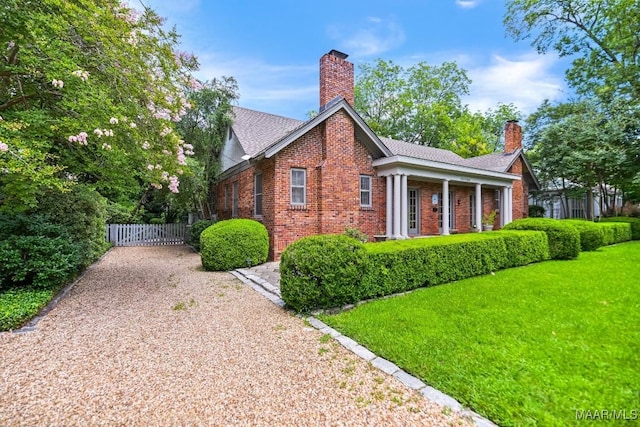1327 Woodward Ave, Montgomery, AL 36106 - view of home's exterior featuring brick siding, a chimney, and a gate