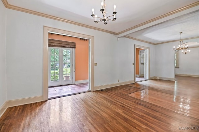 1327 Woodward Ave, Montgomery, AL 36106 - empty room with a chandelier, wood finished floors, and crown molding