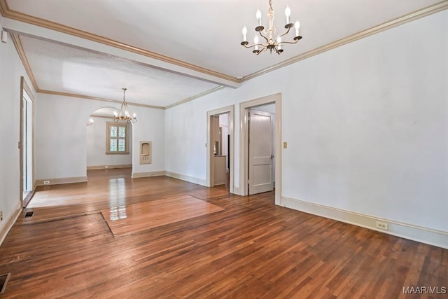 1327 Woodward Ave, Montgomery, AL 36106 - unfurnished dining area with a chandelier, crown molding, wood finished floors, and arched walkways