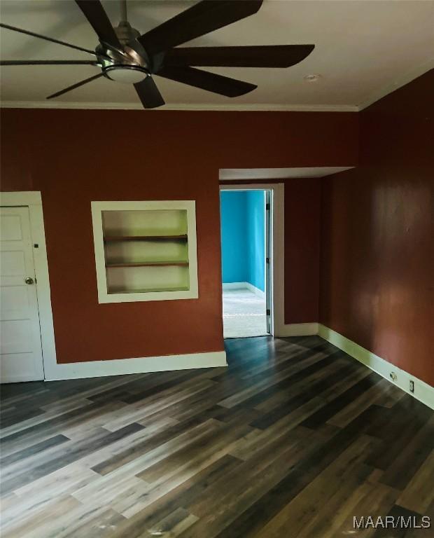 905 Milly Francis St, Wetumpka, AL 36092 - empty room featuring crown molding, dark wood finished floors, built in features, and a ceiling fan