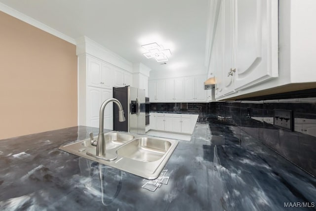 3505 Falcon Ridge Ct, Montgomery, AL 36111 - kitchen with stainless steel fridge, white cabinetry, backsplash, dark stone counters, and crown molding