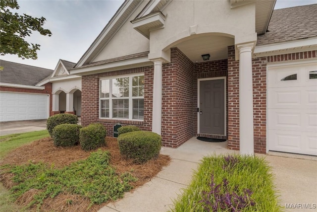 9621 Colleton Pl, Montgomery, AL 36117 - view of exterior entry featuring brick siding, stucco siding, a shingled roof, and a garage