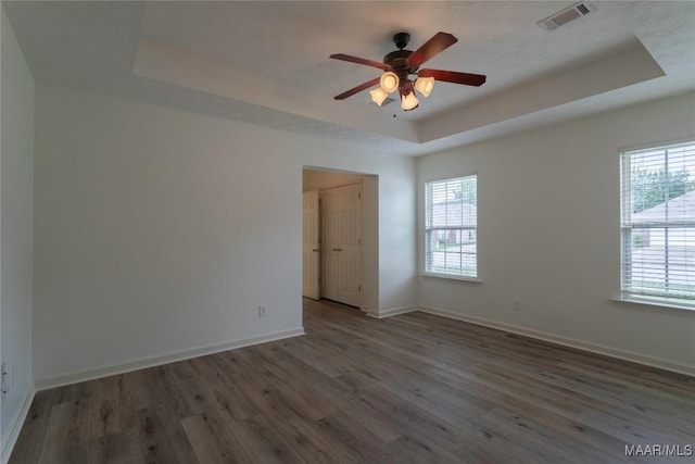 9621 Colleton Pl, Montgomery, AL 36117 - unfurnished room with a raised ceiling, wood finished floors, and a ceiling fan