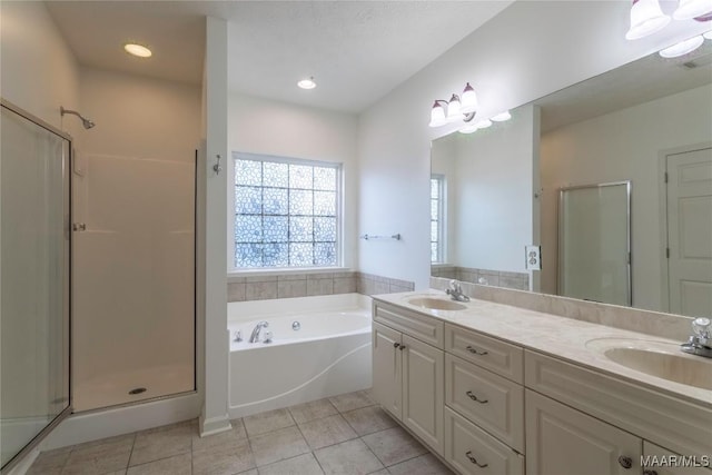 9621 Colleton Pl, Montgomery, AL 36117 - bathroom with tile patterned flooring, a shower stall, double vanity, a garden tub, and recessed lighting