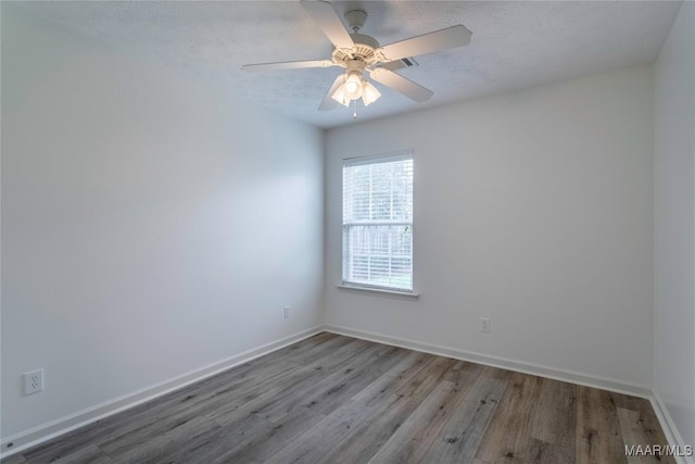 9621 Colleton Pl, Montgomery, AL 36117 - empty room with wood finished floors, ceiling fan, and a textured ceiling