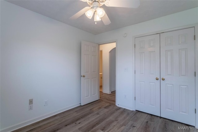 9621 Colleton Pl, Montgomery, AL 36117 - unfurnished bedroom with wood finished floors, a closet, a ceiling fan, and arched walkways
