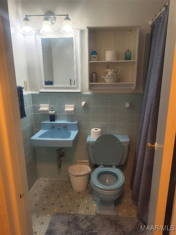 2205 Old Orrville Rd, Selma, AL 36701 - bathroom with tile walls, tile patterned flooring, and a shower with shower curtain