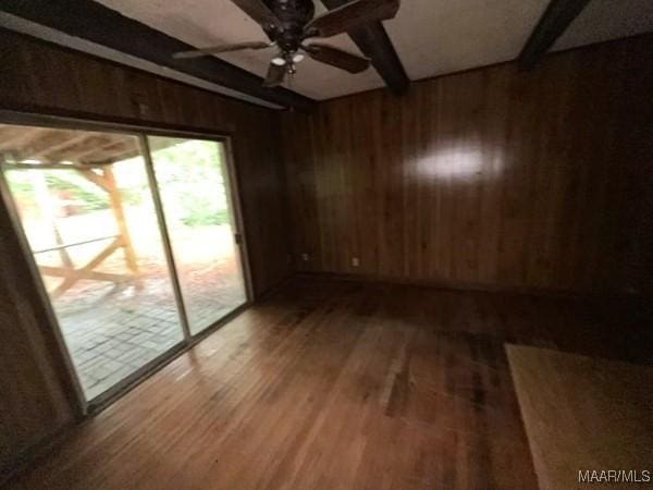 2711 Gwynnbrook Rd, Montgomery, AL 36116 - unfurnished room featuring beamed ceiling, wooden walls, wood finished floors, and a ceiling fan