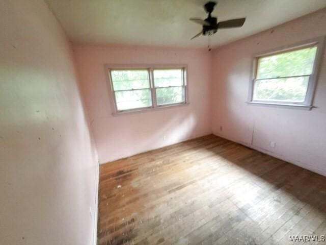 2711 Gwynnbrook Rd, Montgomery, AL 36116 - empty room with wood finished floors, healthy amount of natural light, and a ceiling fan