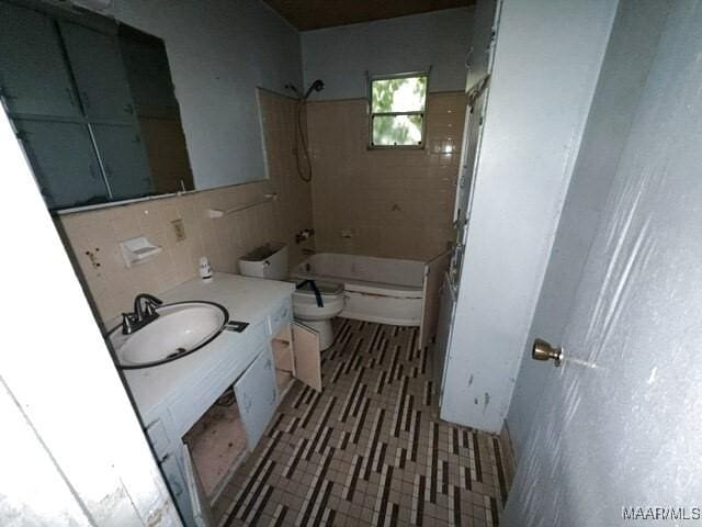 2711 Gwynnbrook Rd, Montgomery, AL 36116 - bathroom featuring vanity, washtub / shower combination, tile walls, and tile patterned floors