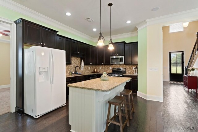 301 Eastgate Dr, Prattville, AL 36066 - kitchen featuring stainless steel appliances, healthy amount of natural light, backsplash, a breakfast bar, and ornamental molding