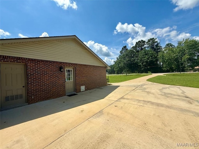 311 Old Marion Junction Rd, Selma, AL 36701 - view of property exterior featuring brick siding, a patio area, a yard, and concrete driveway