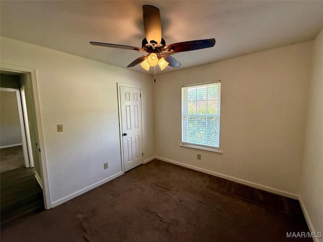 311 Old Marion Junction Rd, Selma, AL 36701 - unfurnished bedroom with dark colored carpet and a ceiling fan