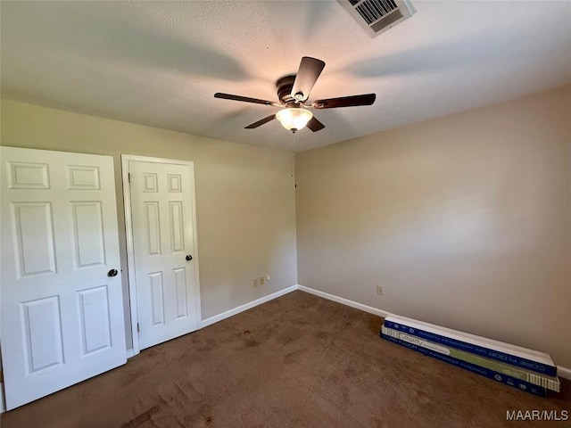 311 Old Marion Junction Rd, Selma, AL 36701 - unfurnished bedroom with dark carpet and a ceiling fan