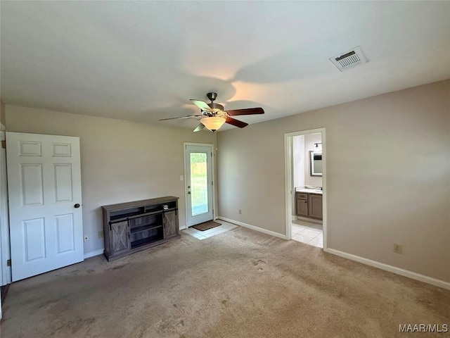 311 Old Marion Junction Rd, Selma, AL 36701 - unfurnished living room with light carpet, a ceiling fan, and a fireplace
