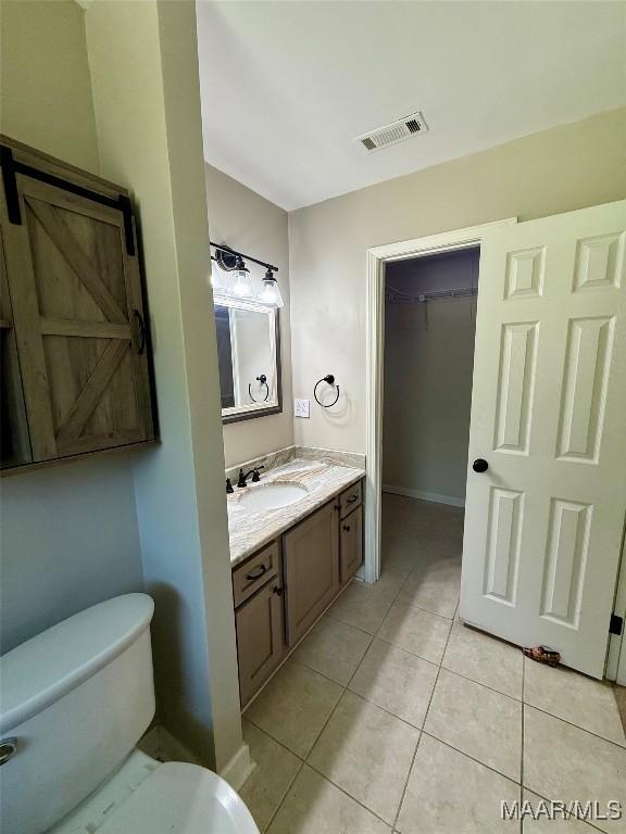 311 Old Marion Junction Rd, Selma, AL 36701 - bathroom featuring vanity, tile patterned flooring, and a spacious closet