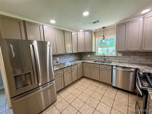 311 Old Marion Junction Rd, Selma, AL 36701 - kitchen featuring stainless steel appliances, ornamental molding, backsplash, light tile patterned floors, and pendant lighting
