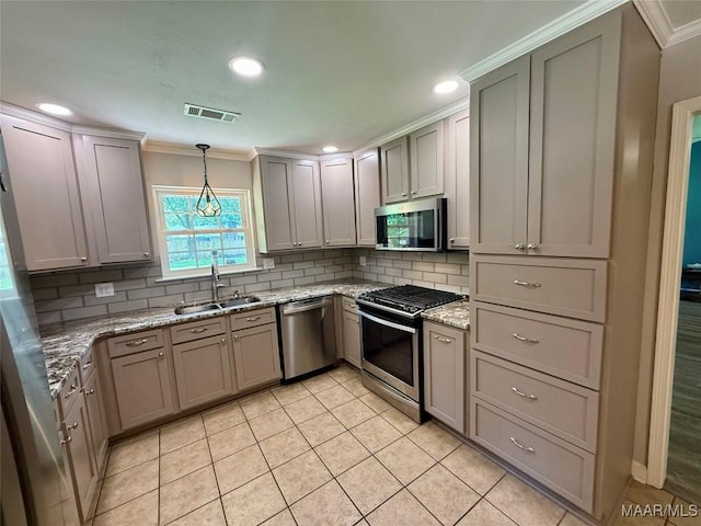 311 Old Marion Junction Rd, Selma, AL 36701 - kitchen with appliances with stainless steel finishes, ornamental molding, light tile patterned floors, backsplash, and pendant lighting