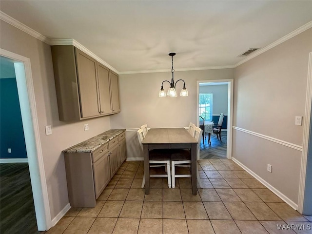 311 Old Marion Junction Rd, Selma, AL 36701 - dining space with a chandelier, crown molding, and light tile patterned floors