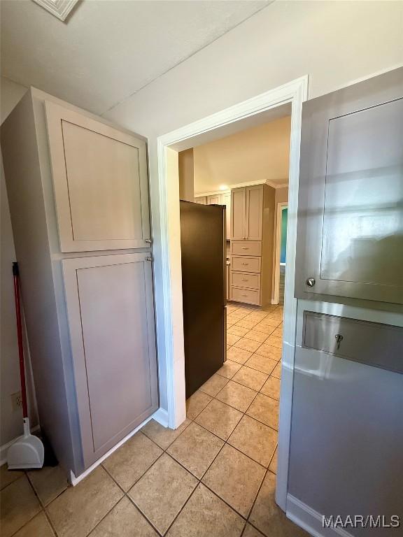 311 Old Marion Junction Rd, Selma, AL 36701 - kitchen with freestanding refrigerator and light tile patterned flooring