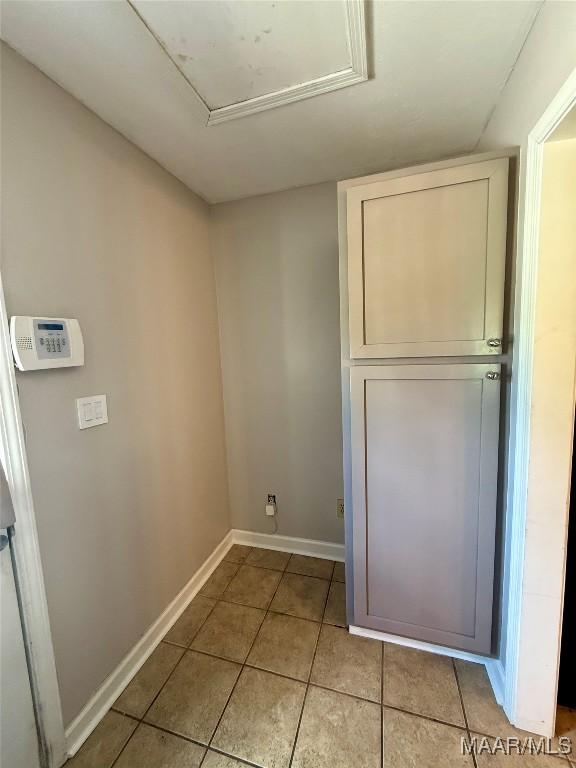 311 Old Marion Junction Rd, Selma, AL 36701 - laundry area featuring light tile patterned floors and attic access