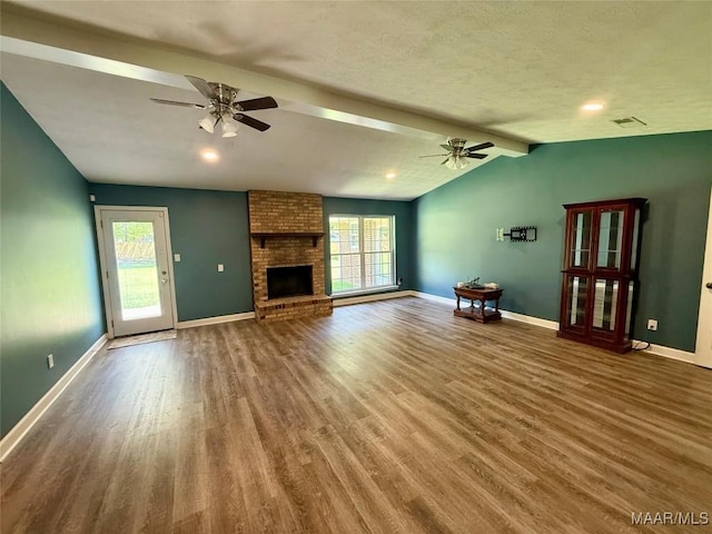 311 Old Marion Junction Rd, Selma, AL 36701 - unfurnished living room featuring ceiling fan, wood finished floors, and a brick fireplace