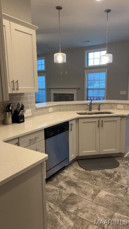 1008 Overture Dr, Montgomery, AL 36117 - kitchen with dishwasher, white cabinetry, light countertops, tasteful backsplash, and pendant lighting