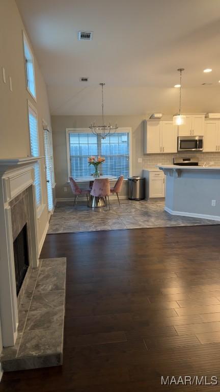 1008 Overture Dr, Montgomery, AL 36117 - dining room with dark wood-style floors, a high end fireplace, recessed lighting, and a chandelier